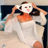 Person wearing a Light face mask with 'ZAO' branding in a bedroom setting.