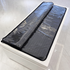 Black mat with reflective surface on a white platform