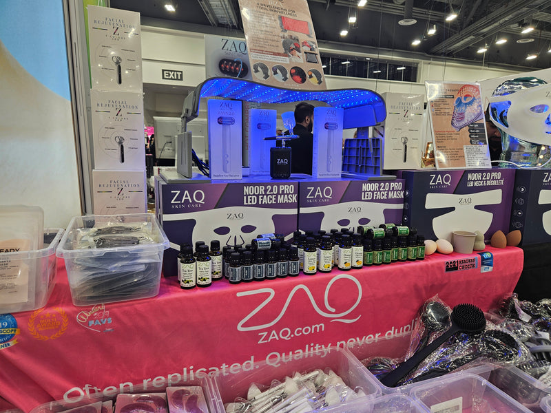 ZAQ product display at a trade show booth with various products on a table.