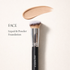 Makeup brush with foundation application on a light background