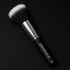Makeup brush with ZAO MAKEUP branding on a black background