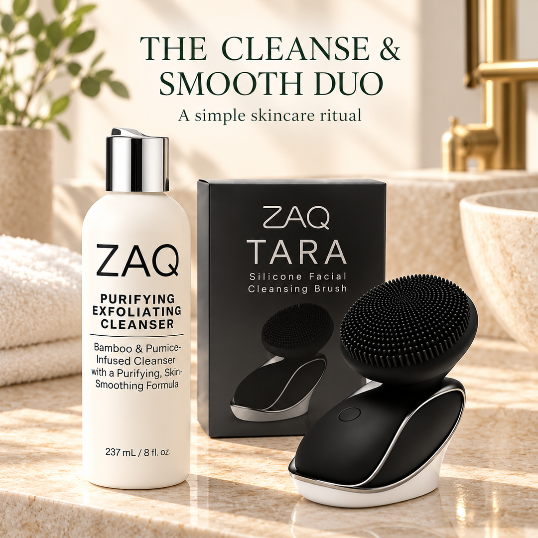 ZAQ Tara silicone facial cleansing brush in black and white shown next to its black packaging box on a marble countertop, with a bottle of purifying exfoliating cleanser behind them. Text at the top reads 'THE CLEANSE & SMOOTH DUO'.