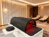 ZAQ LED light therapy device in a modern room with marble walls and white furniture.