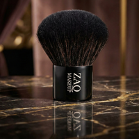 Makeup brush with black bristles on a marble surface, featuring the ZAO MakeUp brand.