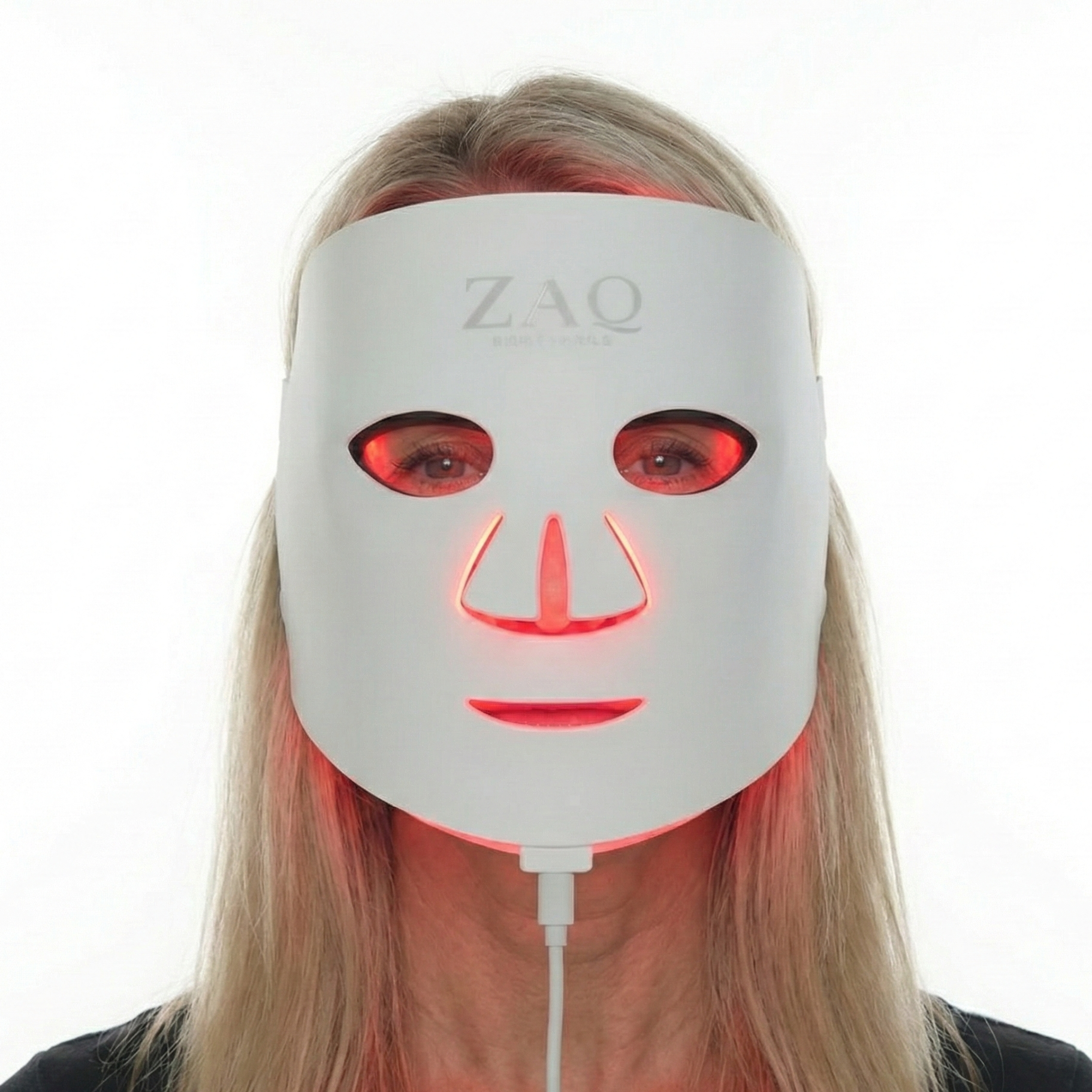 Person wearing a ZAQ LED face mask on a white background