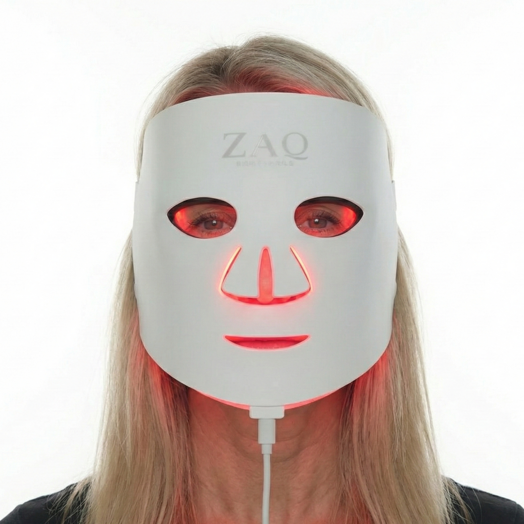 Person wearing a ZAQ LED face mask on a white background
