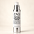A bottle of ZAQ Peptide Booster Serum with a white label, silver pump collar, and silver metallic base, set against a solid cream background.