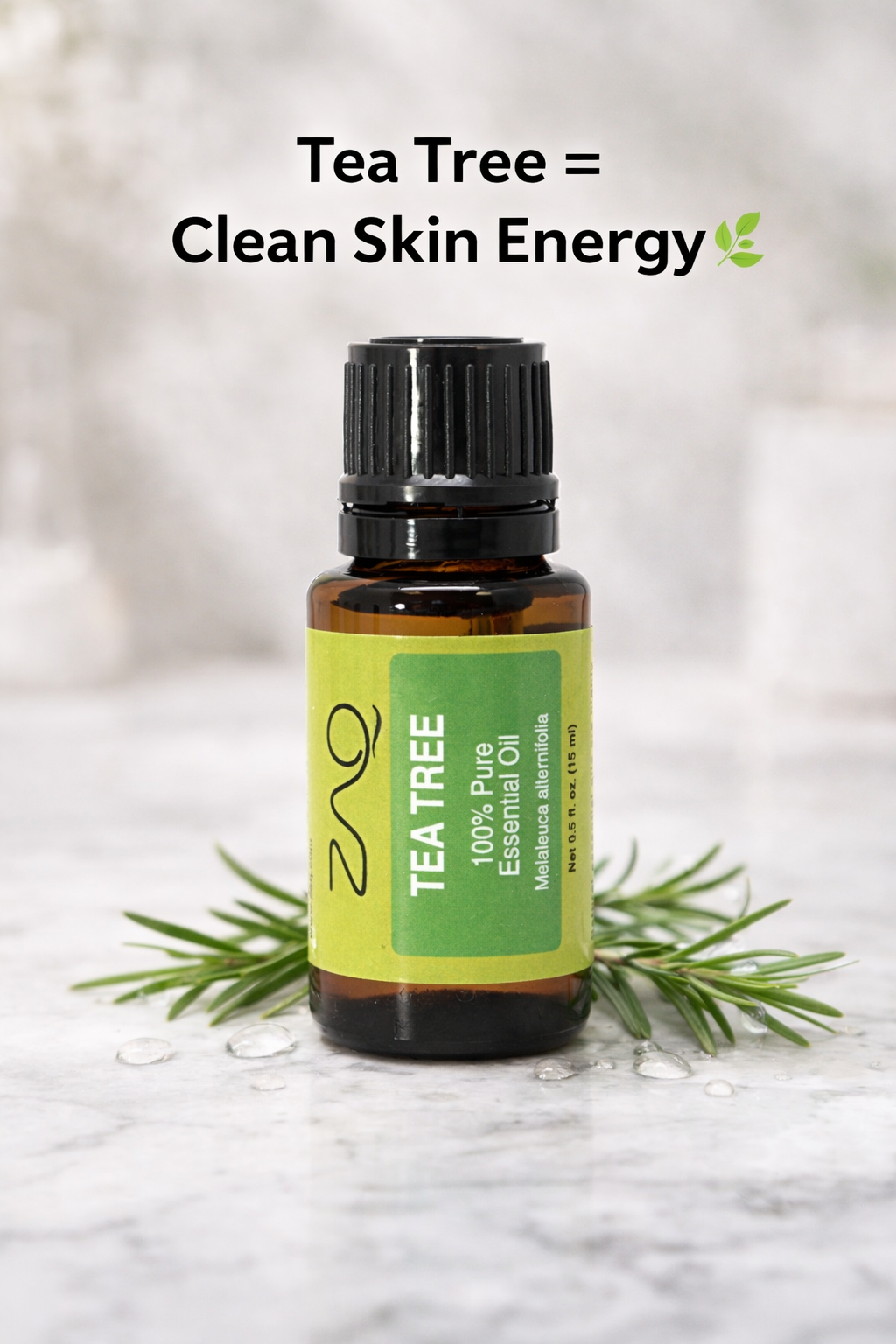 Bottle of ZAO Tea Tree essential oil with a sprig of tea tree leaves on a light background.