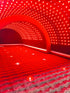 Red LED light tunnel with a textured floor