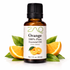 Bottle of ZAO Orange essential oil with oranges and leaves on a white background
