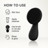 Black facial cleansing brush with usage instructions on a white background