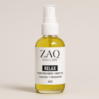 Bottle of ZAQ Skin Care Relax Purifying Bath + Body Oil on a beige background