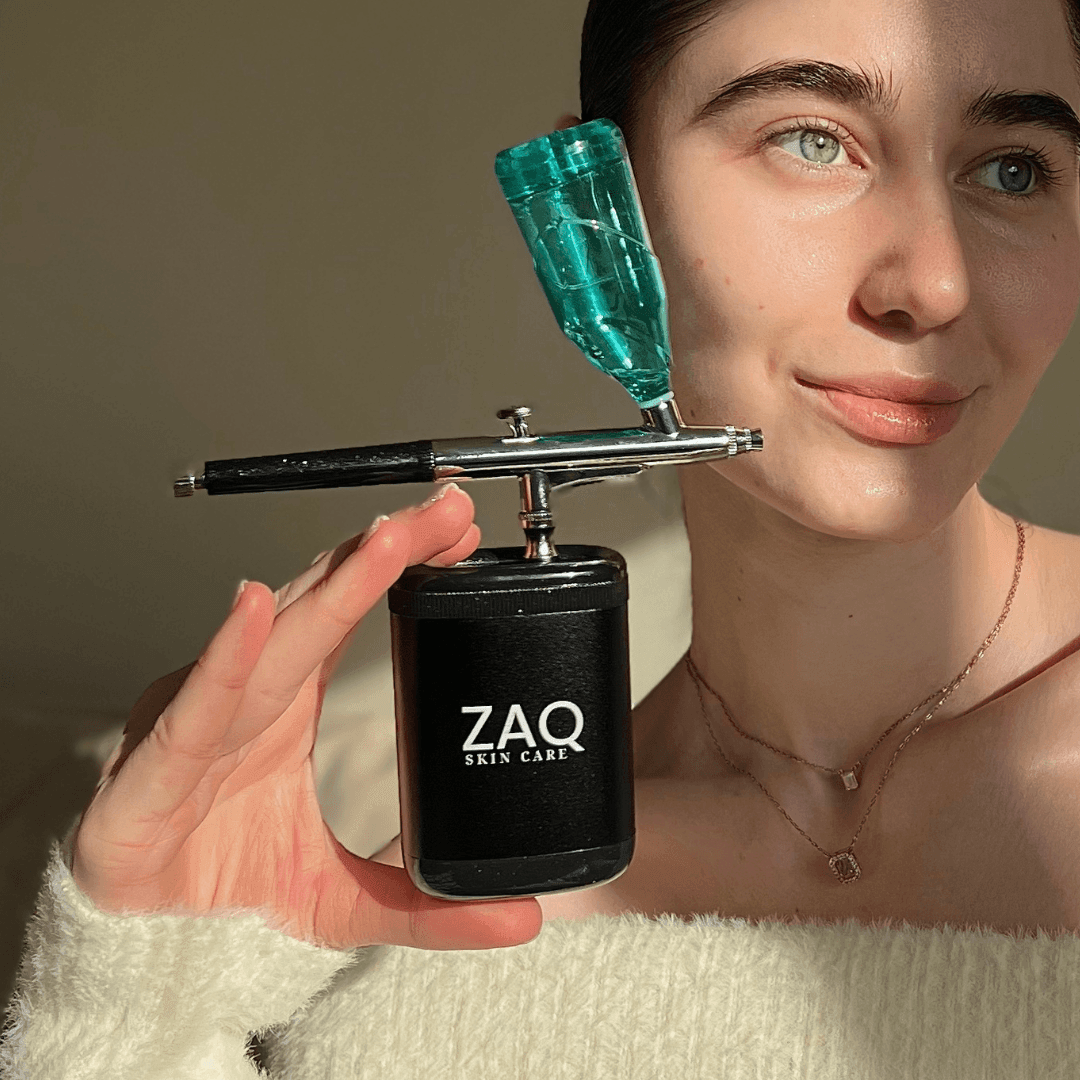 Person holding a ZAQ skin care oxygen device close to their face.