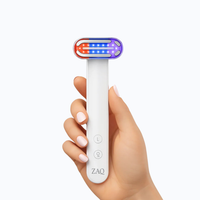 Hand holding a ZAQ Zayn Wand device on a white background